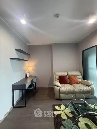 Modern living room with cozy sofa, stylish desk, and elegant decor in a contemporary apartment.