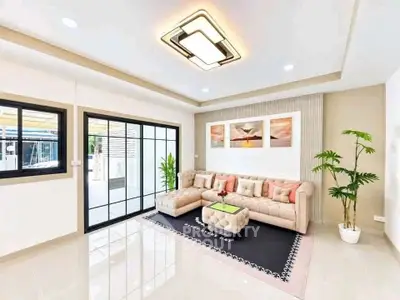 Modern living room with elegant decor and large windows for natural light