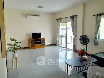 Spacious living room with balcony access and modern furnishings