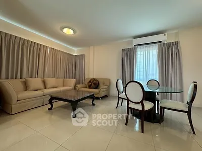 Spacious living room with elegant furniture and natural light, perfect for relaxation and entertaining.