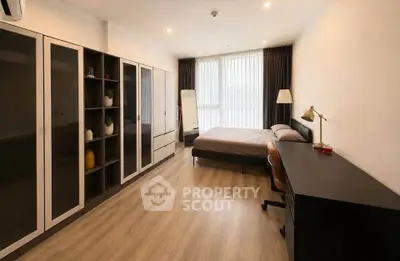 Spacious modern bedroom with large wardrobe and sleek wooden flooring