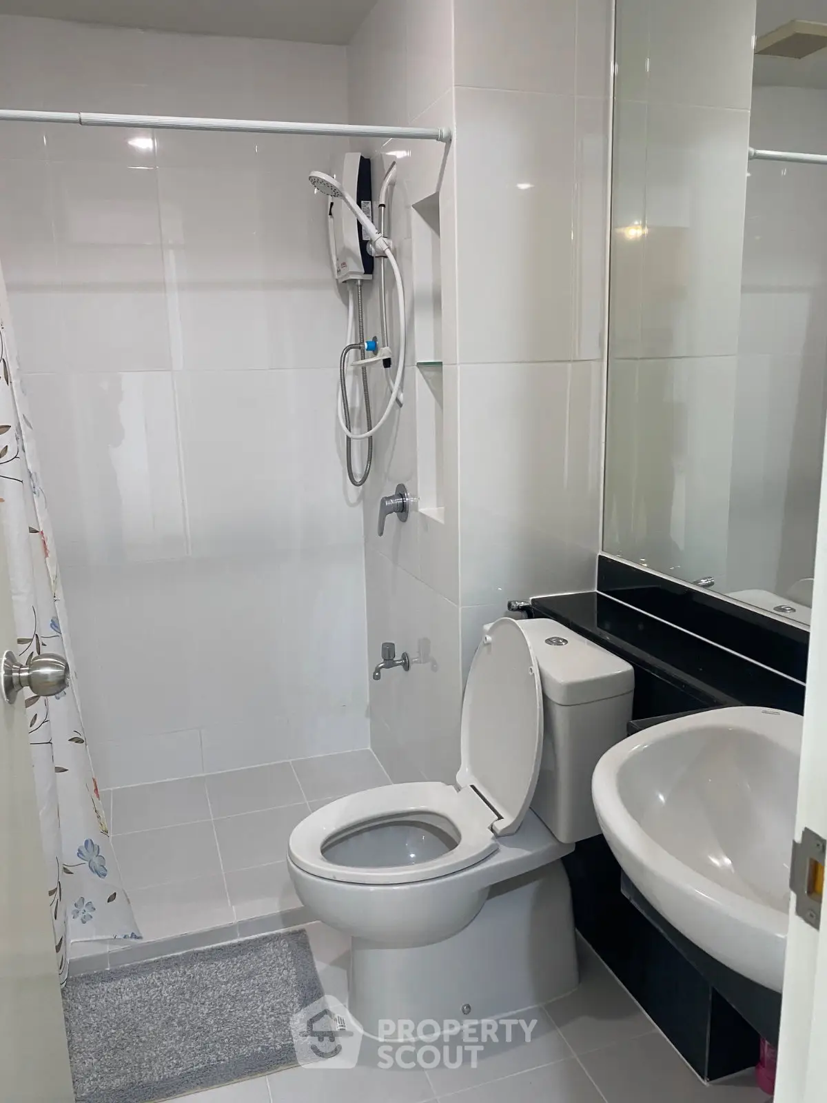 Modern bathroom with sleek fixtures and shower in a contemporary apartment.