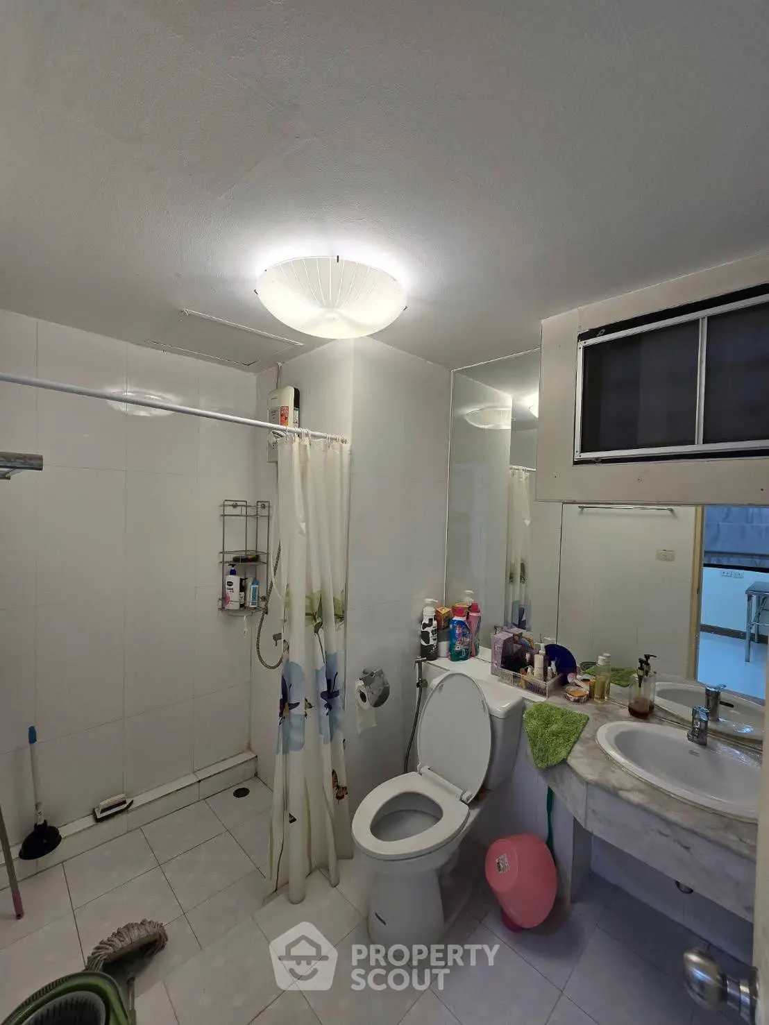 Spacious bathroom with modern fixtures and ample storage space.