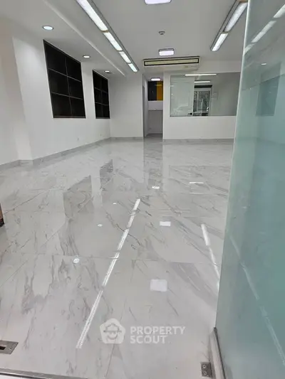 Spacious modern office space with marble flooring and ample lighting