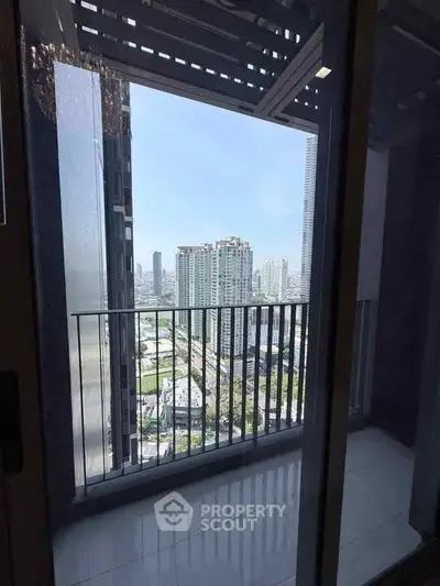 Stunning city view from a modern high-rise balcony, perfect for urban living.