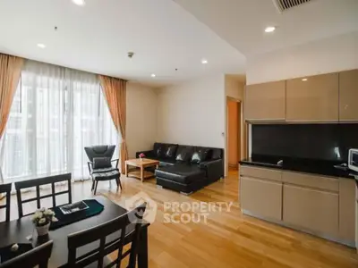 Spacious living room with modern kitchen in open layout apartment.