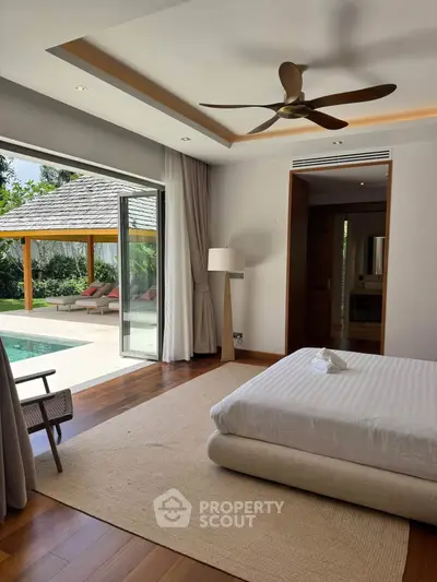 Luxurious bedroom with pool view and modern design in tropical villa