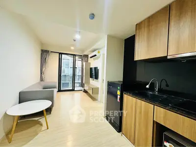 Modern living room with open kitchen and balcony view in stylish apartment