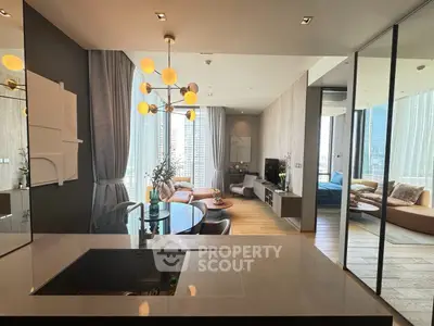 Luxurious modern living room with open kitchen and stunning city view, featuring elegant decor and ample natural light.