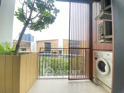 Modern balcony with washing machine and scenic view of contemporary buildings.
