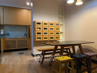 Modern dining area with stylish wooden furniture and open kitchen layout