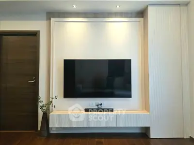 Modern living room with sleek TV setup and stylish wooden flooring