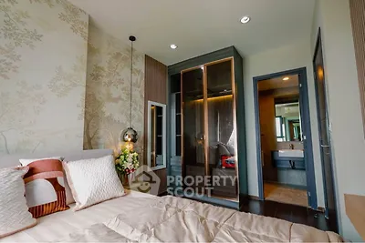 Elegant bedroom with modern decor and ensuite bathroom, featuring stylish lighting and a cozy atmosphere.