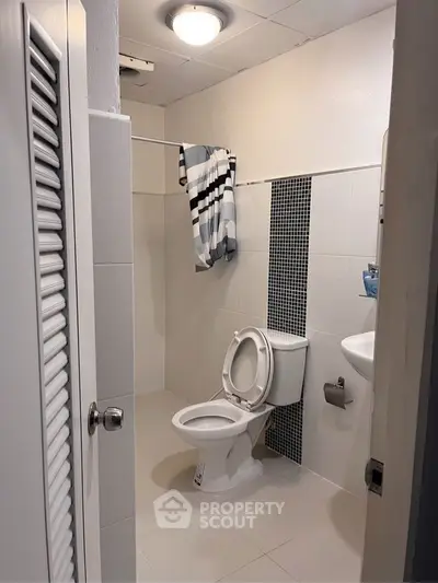 Modern bathroom with sleek design and stylish tile accents.
