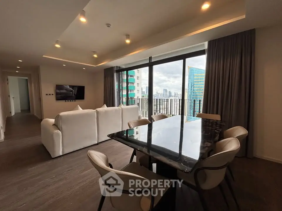 Luxurious modern living room with city view, elegant dining area, and stylish decor in high-rise apartment.