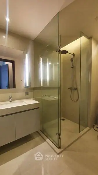Modern bathroom with glass shower enclosure and sleek vanity