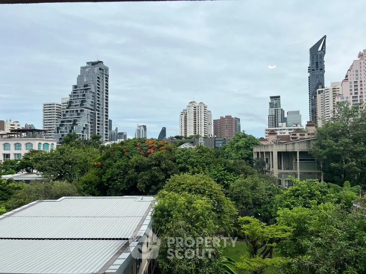 Stunning cityscape view with lush greenery and modern skyscrapers.