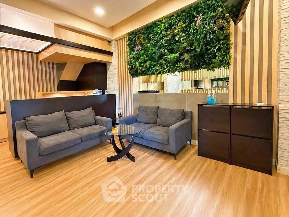 Modern living room with stylish decor and vertical garden wall feature.