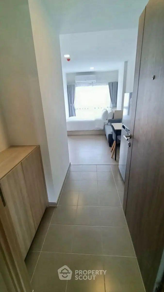 Modern apartment entrance leading to a bright living area with stylish decor.