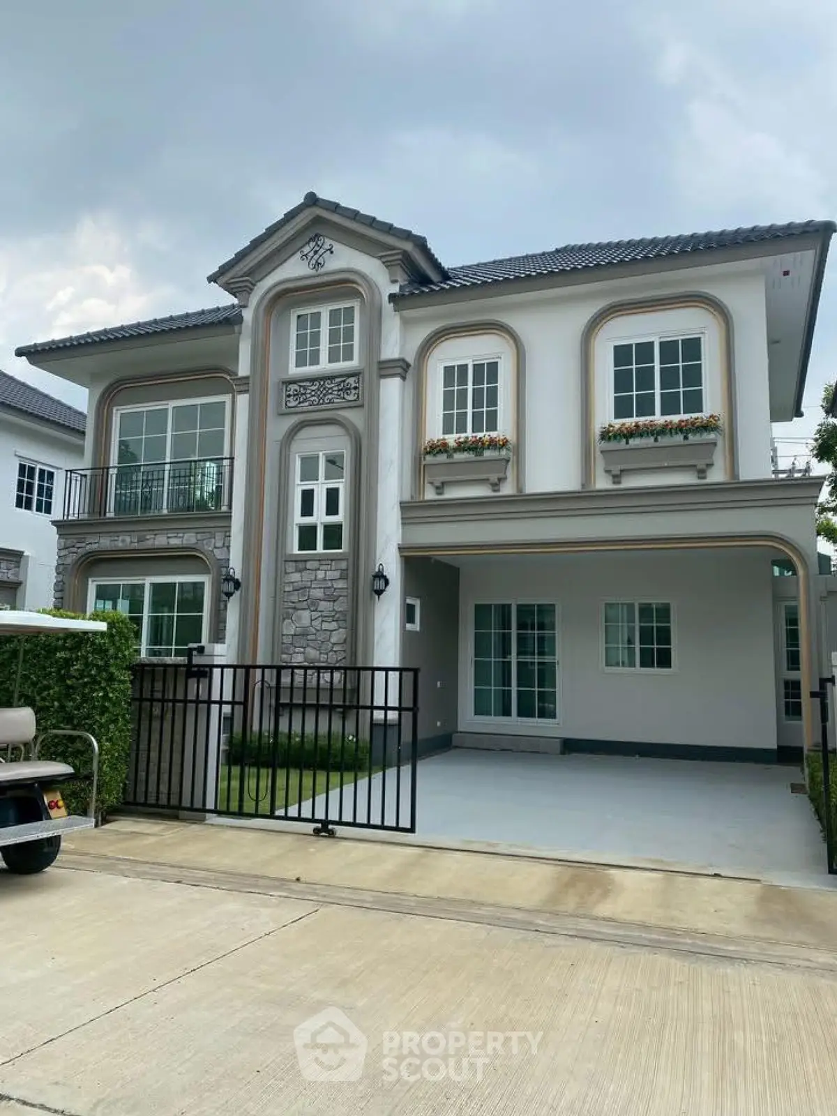 Elegant two-story house with classic architecture and manicured lawn in a serene neighborhood.
