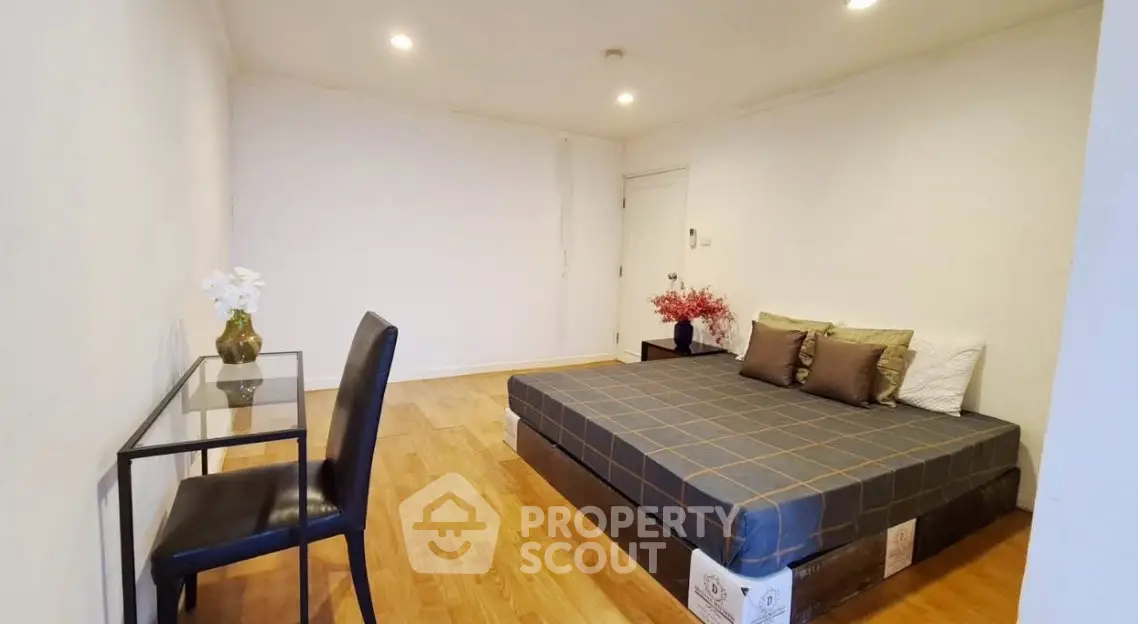 Spacious minimalist bedroom with modern decor and wooden flooring