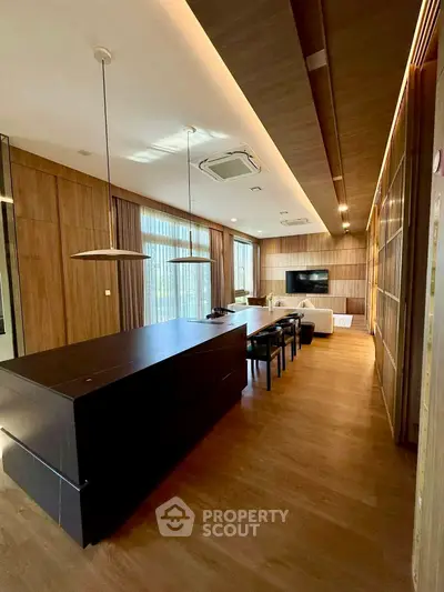 Luxurious modern living room with elegant wooden decor and spacious dining area