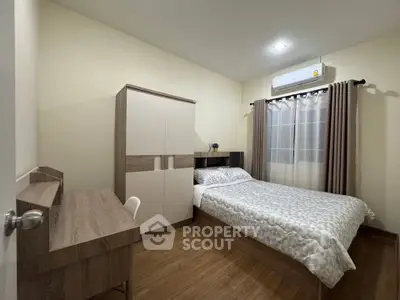 Cozy bedroom with modern furniture and air conditioning, perfect for restful nights.