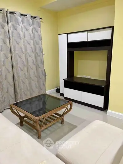 Charming living room with modern entertainment unit and stylish coffee table.