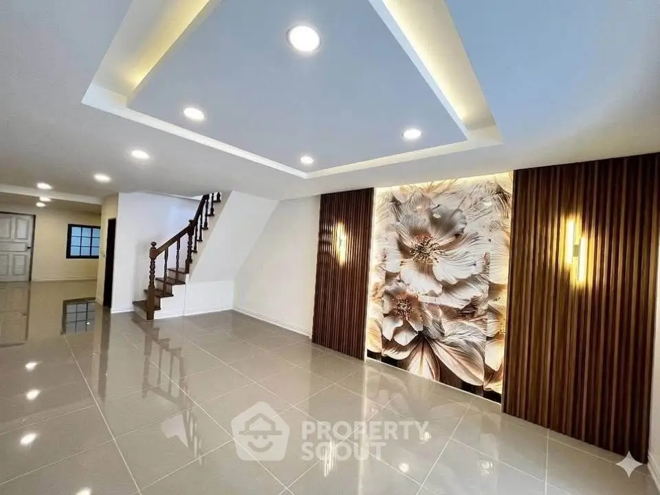 Spacious modern living room with elegant lighting and artistic wall decor