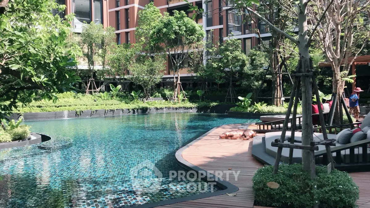 Luxurious residential pool area with lush greenery and modern design, perfect for relaxation and leisure.