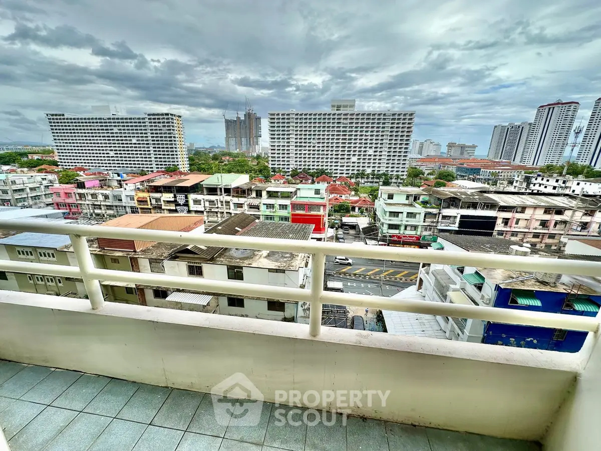 Stunning cityscape view from a high-rise balcony, showcasing urban architecture and skyline.