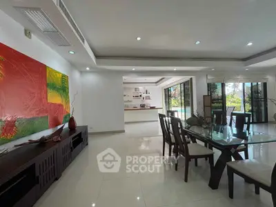 Spacious open-plan living and dining area with modern decor and garden view, perfect for entertaining.