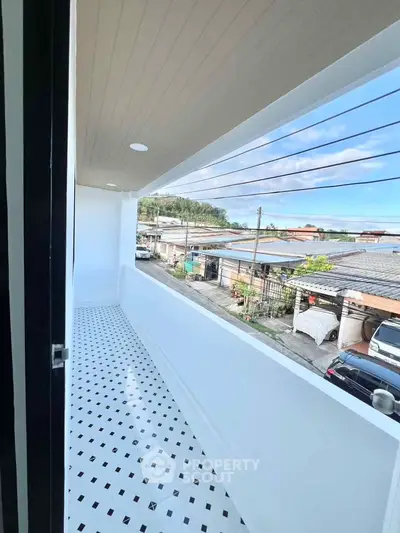 Spacious balcony with scenic neighborhood view, perfect for relaxation and outdoor enjoyment.