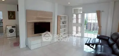 Spacious living room with modern entertainment center and garden view