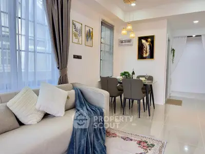 Modern living and dining area with elegant decor and natural light