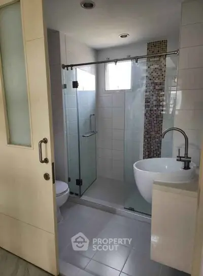 Modern bathroom with glass shower and sleek sink design