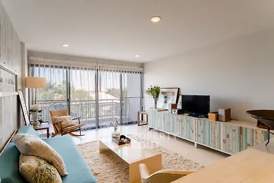 Stylish living room with modern decor and large windows offering natural light.