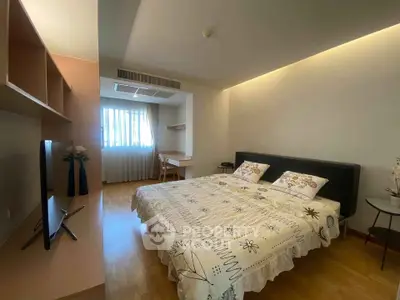Spacious bedroom with modern decor and natural light, featuring a comfortable bed and stylish furnishings.