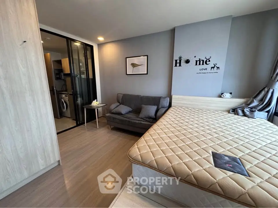 Modern bedroom with cozy sofa and stylish decor in a contemporary apartment.