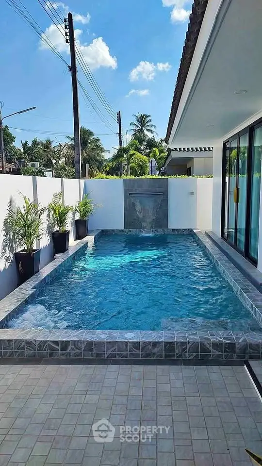 Luxurious private pool with modern design and lush greenery in a serene residential setting.