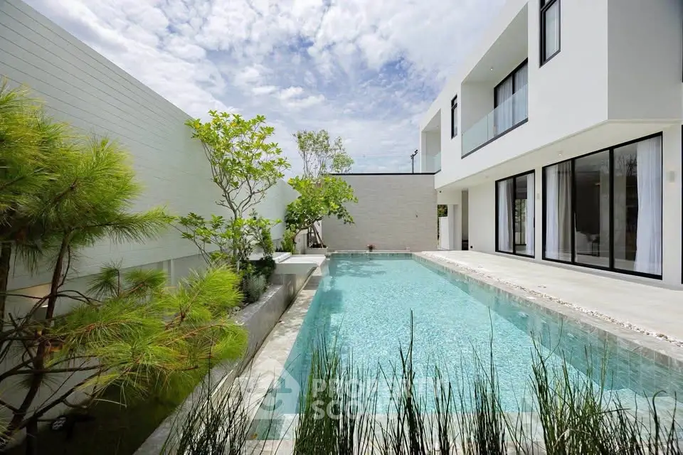 Luxurious modern home with private pool and lush greenery, perfect for relaxation and entertainment.
