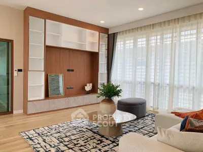 Spacious modern living room with elegant decor and large windows
