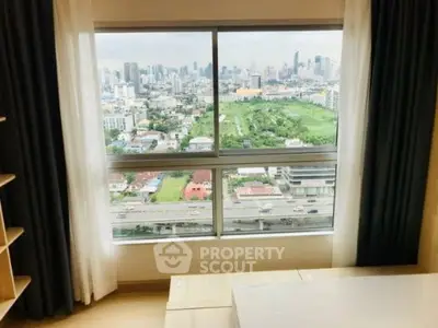 Stunning cityscape view from a modern high-rise apartment window, showcasing urban skyline and greenery.