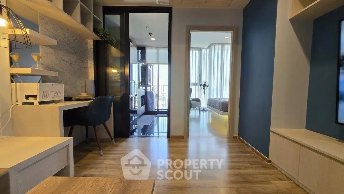 Modern apartment interior with study area and view into bedroom