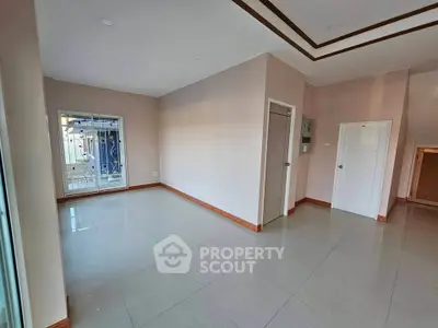 Spacious unfurnished room with large window and modern tile flooring