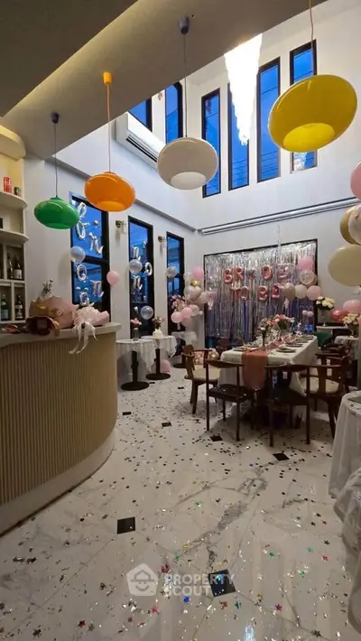 Chic and modern event space with high ceilings and stylish decor, perfect for celebrations.