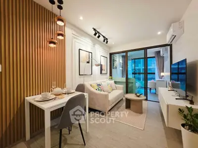 Modern living room with stylish decor and open layout, featuring a cozy dining area and large windows.