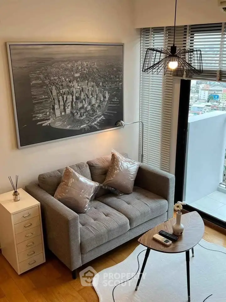 Modern living room with stylish decor and city view balcony.