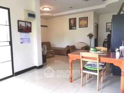 Spacious living room with cozy seating and dining area, perfect for family gatherings.