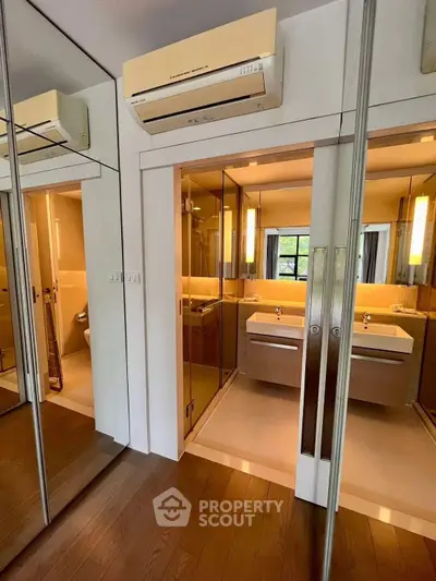 Modern bathroom with mirrored closet doors and sleek design
